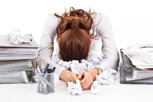 img of a woman distressed looking at papers
